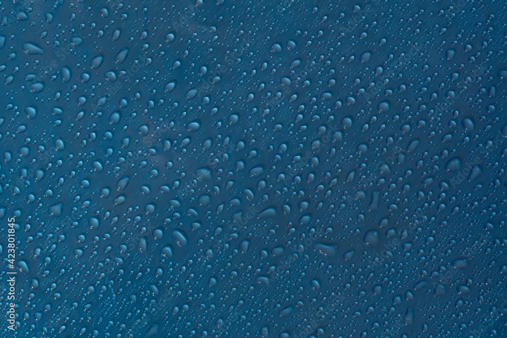 Droplet texture. Wet drop water on glass blue background. Droplet texture. Wet drop water on glass blue background.