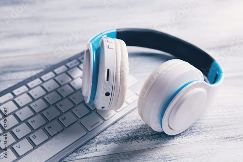 white headphones with computer listening to audio book or music