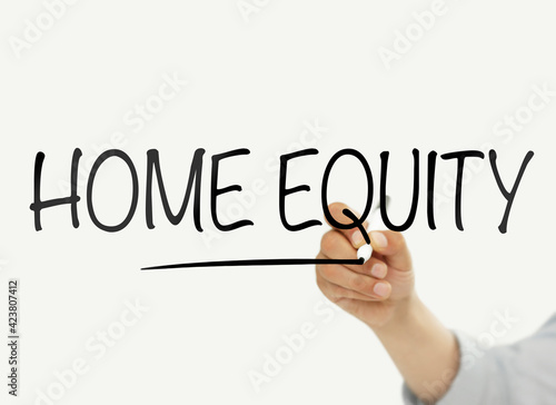 Man writing "Home equity" on a transparent board