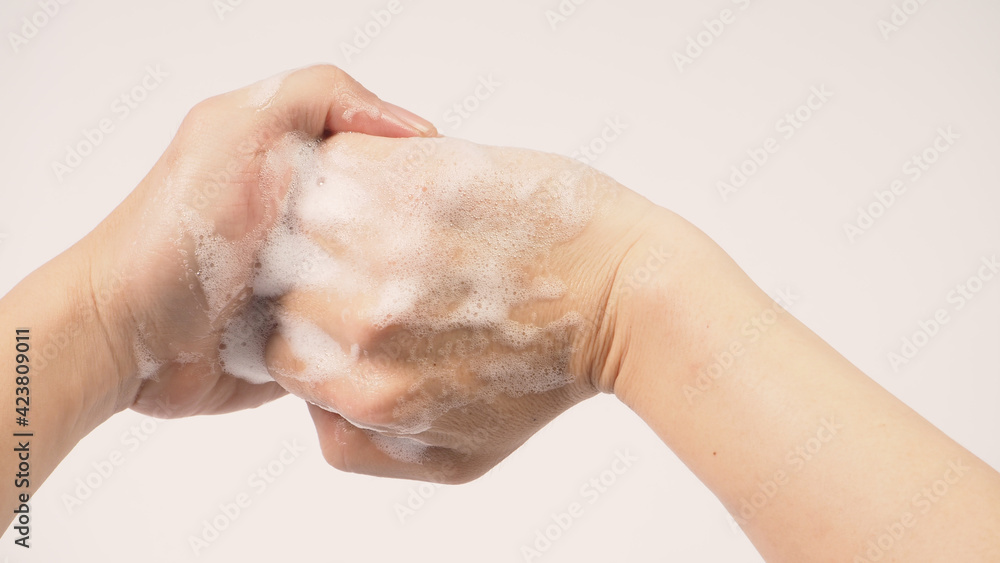 Hands washing gesture with foaming hand soap on white background. Hands washing gesture with foaming hand soap on white background.