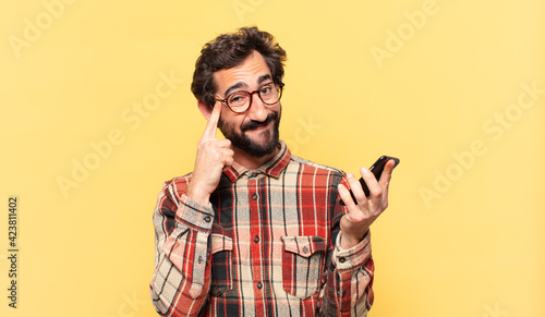 young crazy bearded man thinking expression and holding a phone