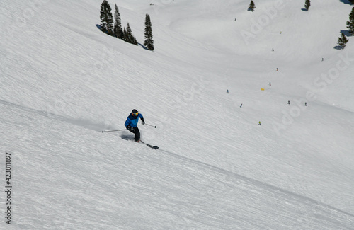 Skier going down the slopes on hi-speed at sunny day with fresh show at Vail ski resort, Colorado