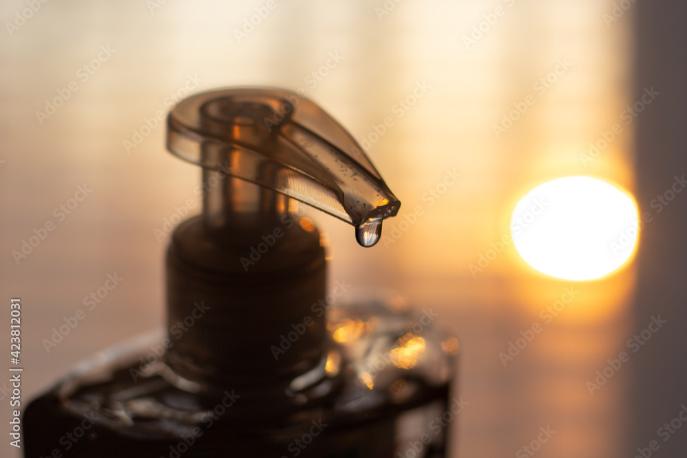 Closeup of a person applying anti-bacterial gel to disinfect their hands. Closeup of a person applying anti-bacterial gel to disinfect their hands.