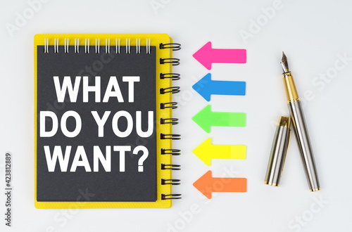 Wallpaper Mural On a white background lies a pen, arrows and a notebook with the inscription - WHAT DO YOU WANT Torontodigital.ca