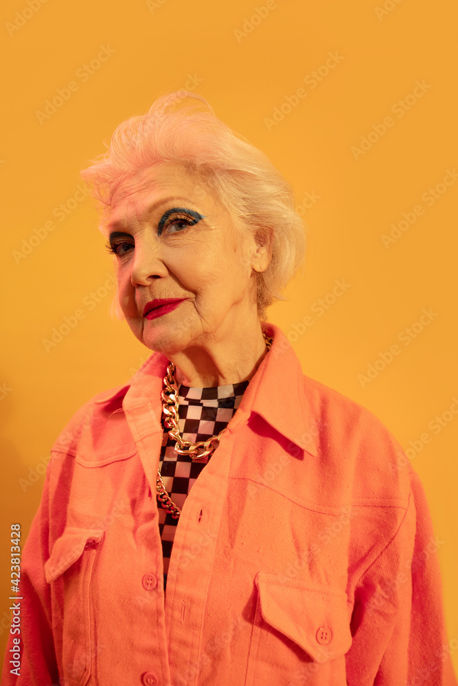 Woman looking confidently at the camera while posing in studio Woman looking confidently at the camera while posing in studio