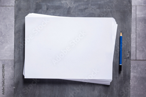 Stack of paper sheet with empty pages on table background. Creative idea concept