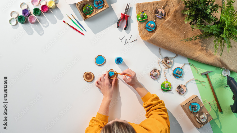 Fototapeta premium Top view of craftswoman making diy decorations, small business and desktop concept.