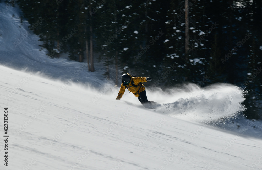 Man snowboarding on snowy hill. Extreme winter sports. Action shot. Vail ski resort, Colorado
