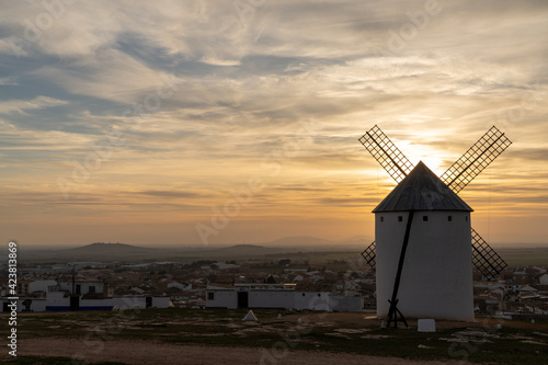 whiteashed Spanish windmill above the plains of La Mancha in central Spain at sunset