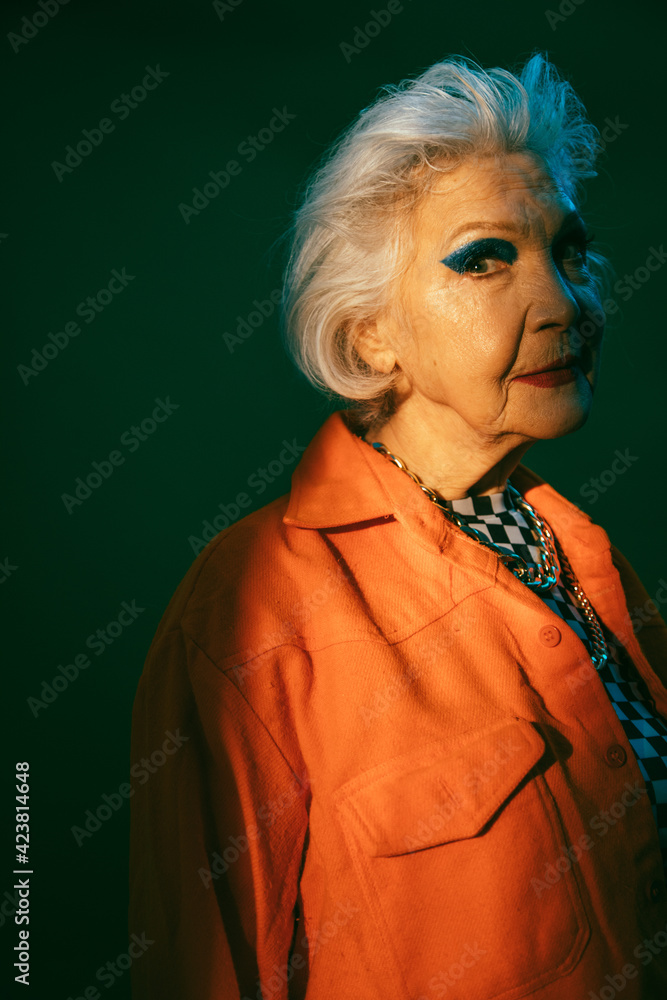Woman with vivid make up looking at the camera while posing at the studio Woman with vivid make up looking at the camera while posing at the studio