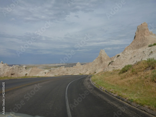 A road going through the surreal landscape and terrain at Badlands National Park in South Dakota