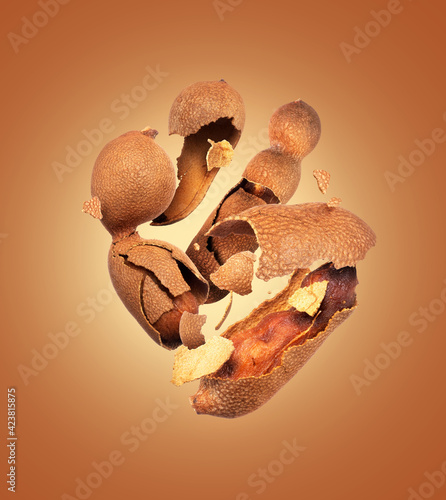 Crushed tamarind in the air close up on a brown background photo