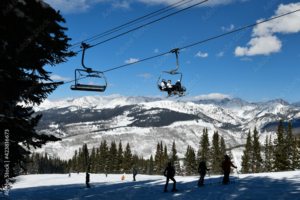 Ski chair lift with skiers. Ski resort in Vail, Colorado, USA