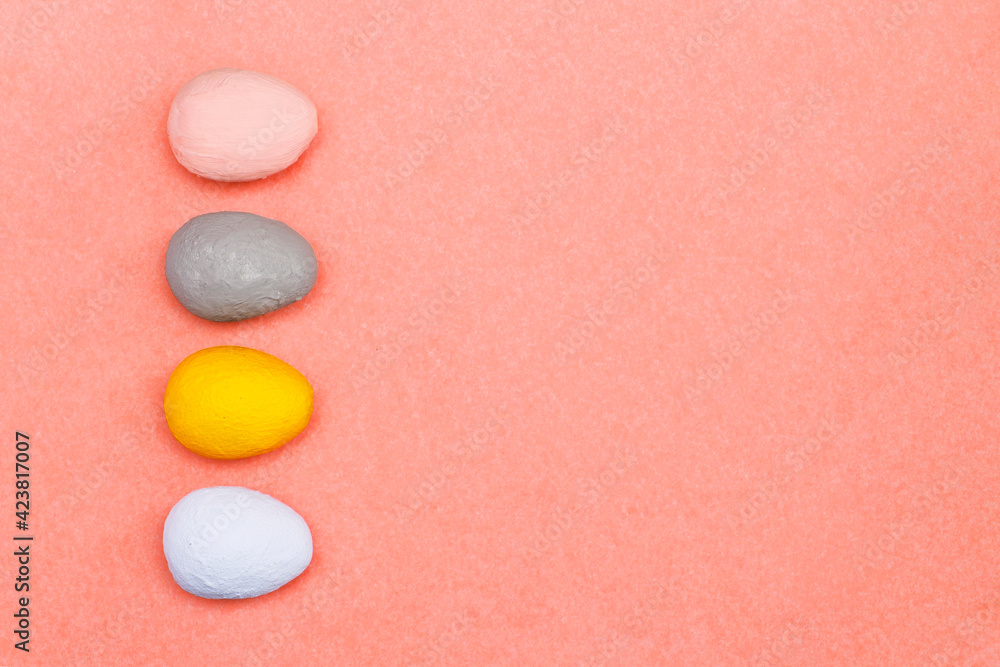 Pink, gray, yellow, light blue decorative eggs on a pink paper background. Easter concept made from hand painted eggs. Pink, gray, yellow, light blue decorative eggs on a pink paper background. Easter concept made from hand painted eggs.