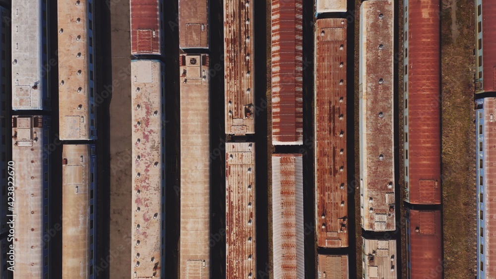 Railway hub showing passenger old crusty trains on tracks next to each other top down view drone moving slowly showing railway tracks positioned parallel. Old Railway Carriages and Wagons 4k Railway hub showing passenger old crusty trains on tracks next to each other top down view drone moving slowly showing railway tracks positioned parallel. Old Railway Carriages and Wagons 4k