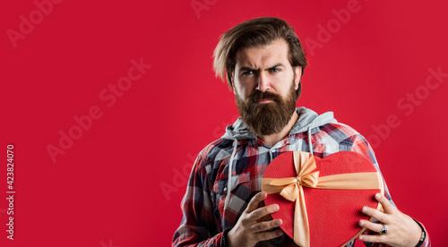 handsome bearded guy with beard and moustache hold gift for love date, present © be free