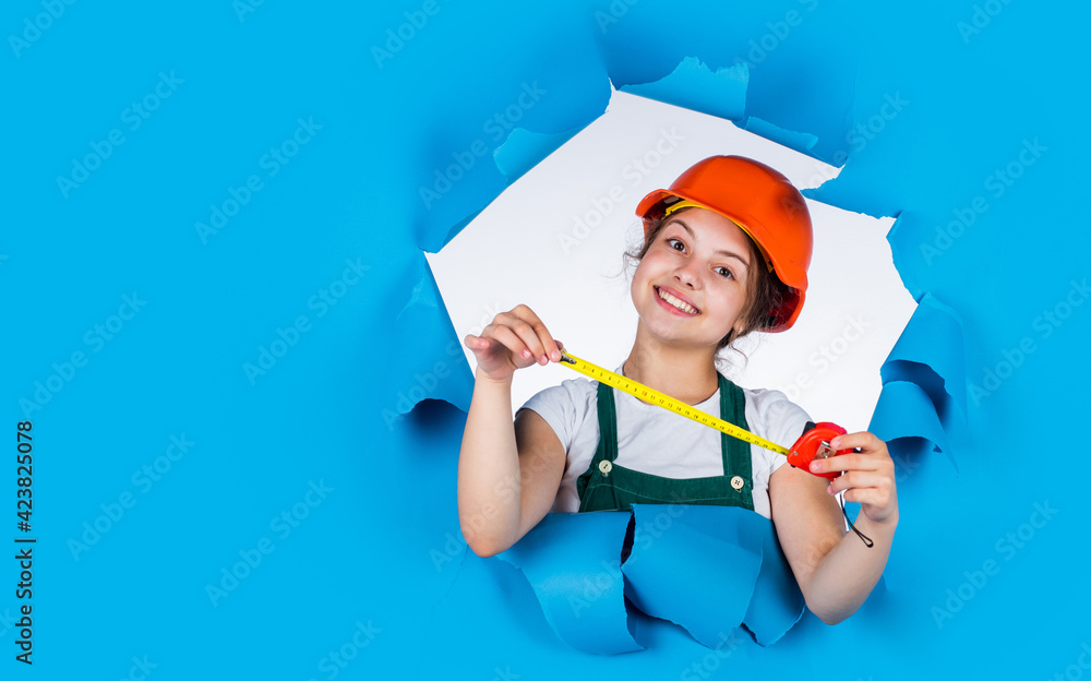 cheerful child laborer using building uniform and tape measure, copy space, labor day cheerful child laborer using building uniform and tape measure, copy space, labor day