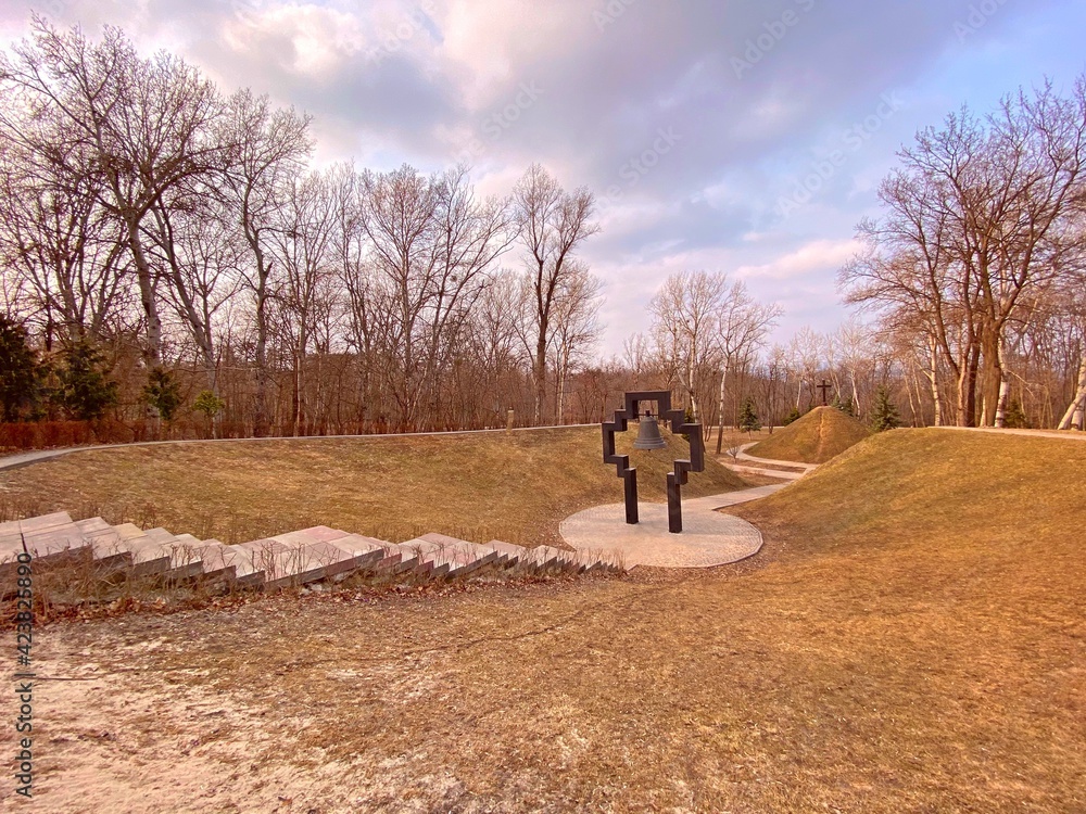 Fototapeta premium Natural park landscape in Kiev Ukraine. Walking in the park. Church bell religious monument. 