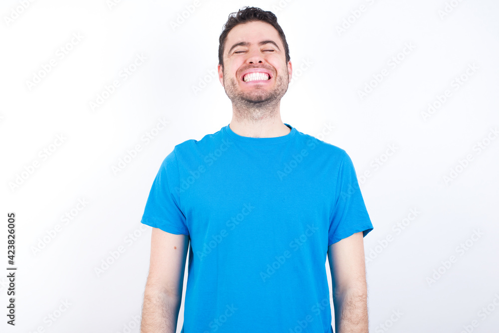 young handsome caucasian man wearing blue t-shirt against white background very happy and excited about new plans. young handsome caucasian man wearing blue t-shirt against white background very happy and excited about new plans.