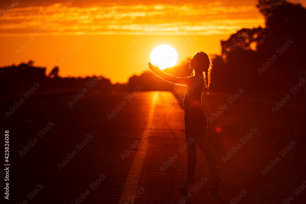 Young woman dancing in summer sunset sky outdoor. People freedom style.