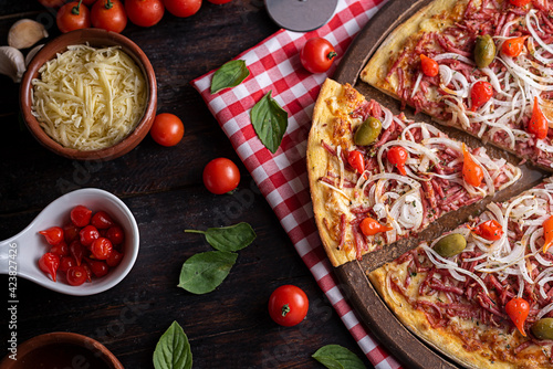 Pizza de calabresa com queijo mussarela, cebola e pimenta biquinho photo