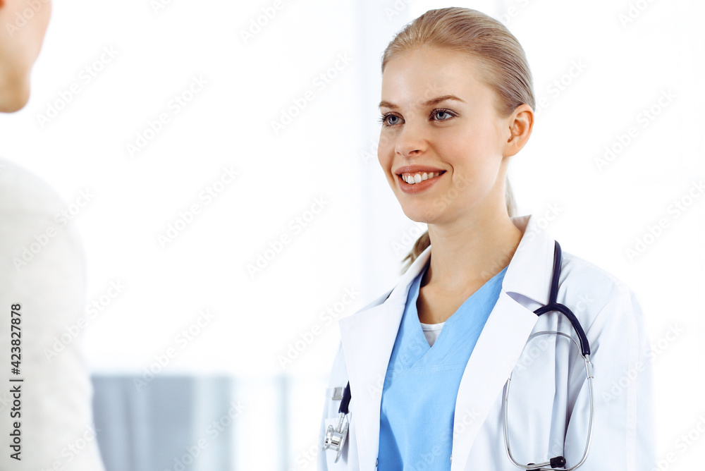 Woman - doctor consults her female patient in clinic. Medicine concept Woman - doctor consults her female patient in clinic. Medicine concept