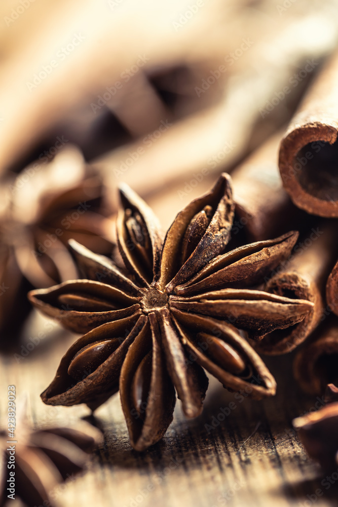 Detail of star anize and cinnamon sticks on a vintage wooden surface Detail of star anize and cinnamon sticks on a vintage wooden surface