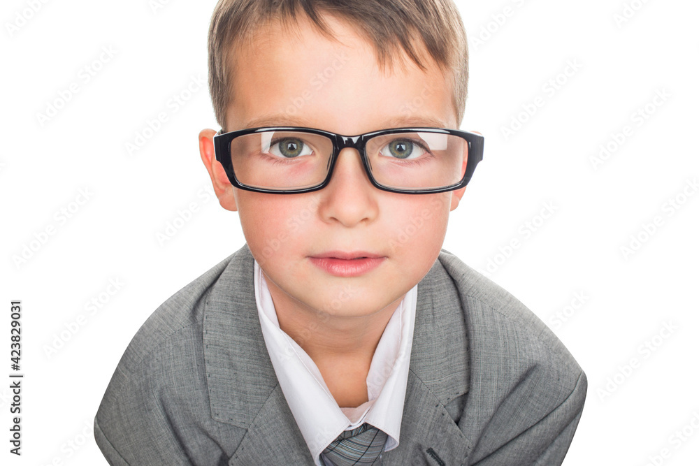Portrait of a cute schoolboy in businessman suit and glases, isolated on white. Handsome child boy in business suit.