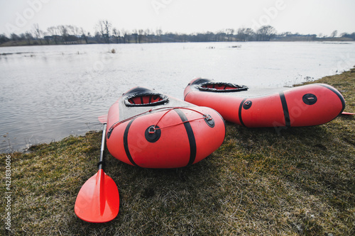 Red packraft rubber boats on the river bank. Selective focus. Active lifestile concept.