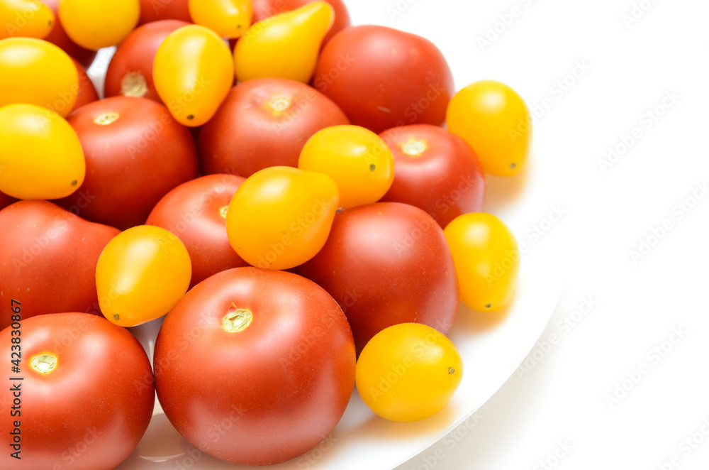 ripe, fresh, natural, multi-colored tomatoes on a white background