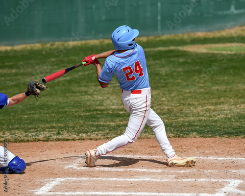Action photo of high school baseball players making amazing plays during a baseball game