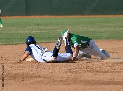 Action photo of high school baseball players making amazing plays during a baseball game