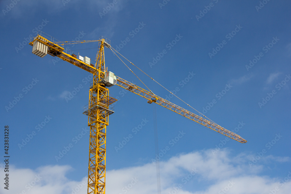 Tower crane against the blue sky. Construction equipment Tower crane against the blue sky. Construction equipment