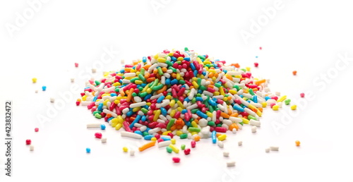 Pile colorful candy sprinkles isolated on white background, side view