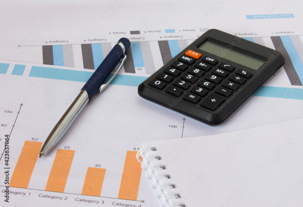 Profit bar chart, pen, notepad and calculator Profit bar chart, pen, notepad and calculator