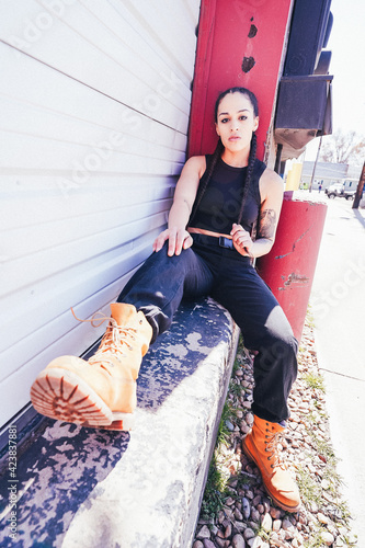 Strong woman of color posing in alley photo