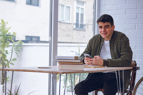 student with mobile phone at home