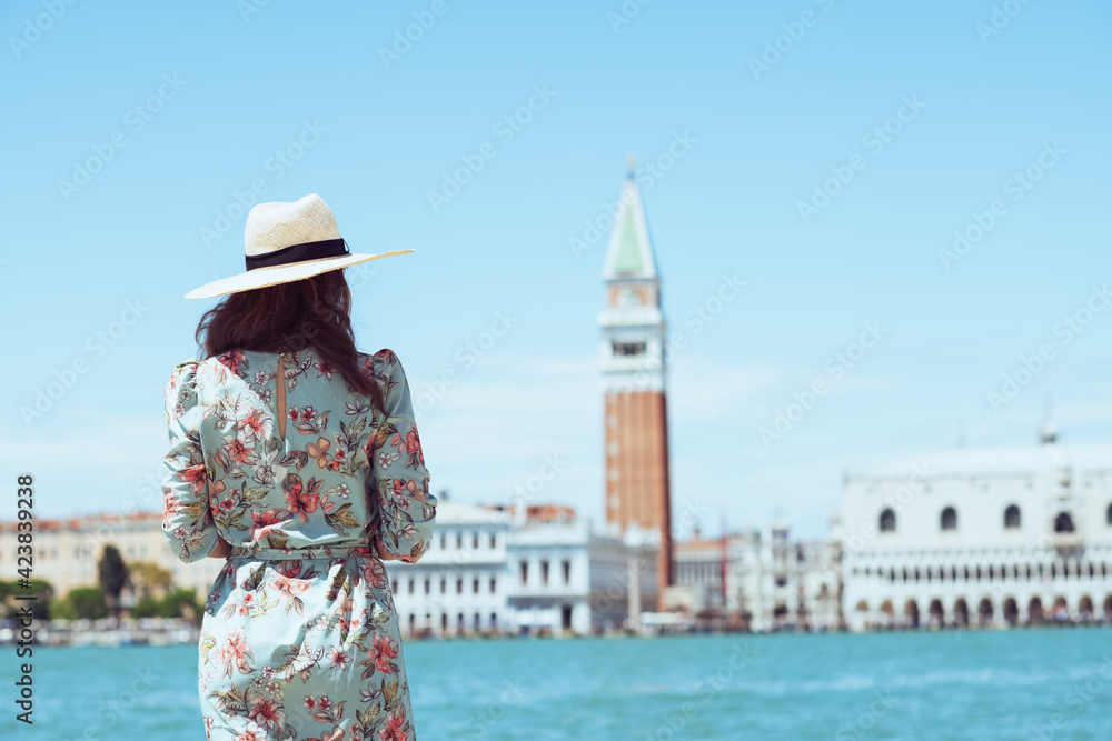 Seen from behind woman in floral dress having walking tour