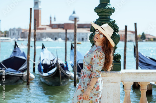 happy young woman in floral dress with sunglasses sightseeing © Alliance