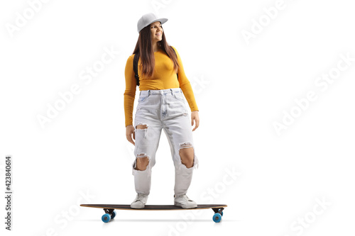 Full length shot of a skater girl riding a longboard
