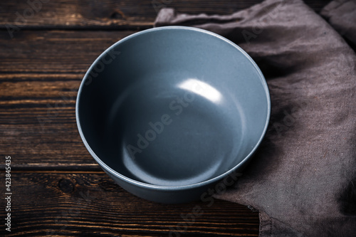 Empty gray plate on a wooden background. Kitchen mockup