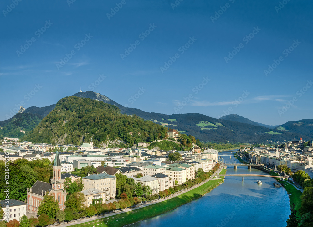 Old town of Salzburg flanked by Kapuzinerberg hill. Capital city of State of Salzburg in Austria, Europe. Historic centre, Salzach river and Alpine surroundings. Birthplace of Wolfgang Amadeus Mozart.