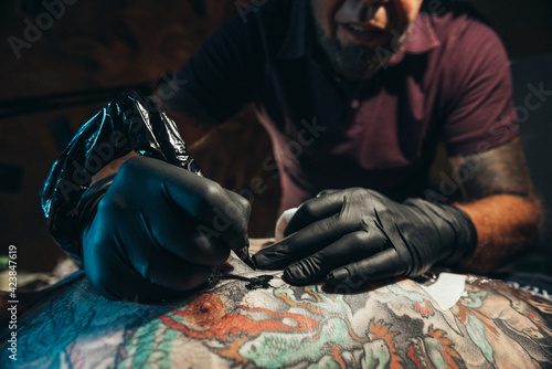 Tattoo artist creating a tattoo