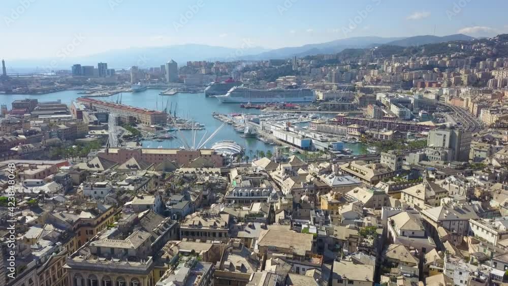 Aerial panoramic drone view of buildings and streets surrounding Port of Genoa.Cruise ships and ferries in port.Old famous city of Italy, with beautiful architecture, houses, roofs, buildings.4K video Aerial panoramic drone view of buildings and streets surrounding Port of Genoa.Cruise ships and ferries in port.Old famous city of Italy, with beautiful architecture, houses, roofs, buildings.4K video