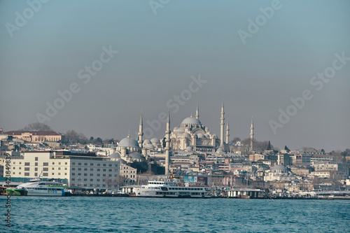 Turkey istanbul 03.03.2021. old and ancient ottoman mosques Yeni Cami mosque in istanbul turkey during morning by taken photo from istanbul bosporus.