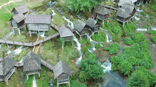 Jajce, Bosnia and Herzegovina - July 16, 2019. Old small wooden mills Mlincici near Jajce on Plivsko Lake in Bosnia and Herzegovina photo