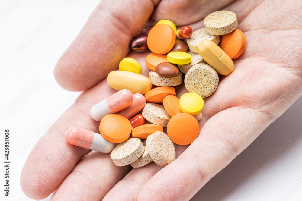 person hold large group different drugs at hand. close up. medication concept person hold large group different drugs at hand. close up. medication concept