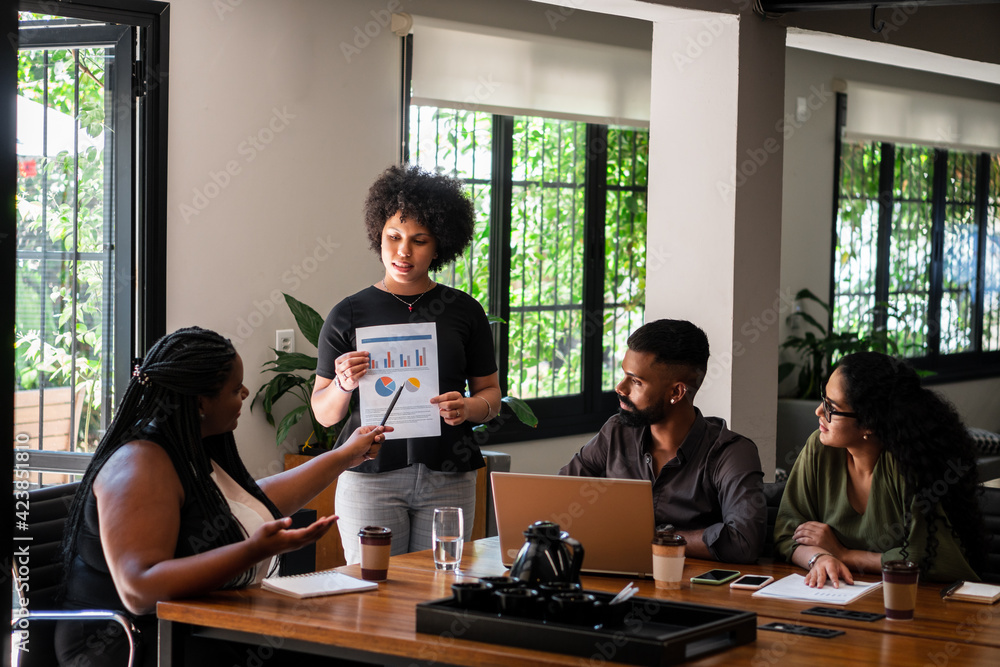 black business woman leading presentation for teammates in the office. . black business woman leading presentation for teammates in the office. .