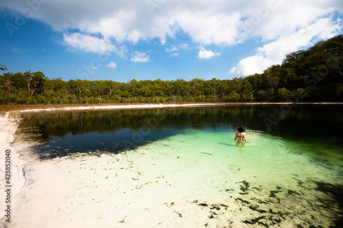 Woman swimming in a secluded lake on Fraser Island