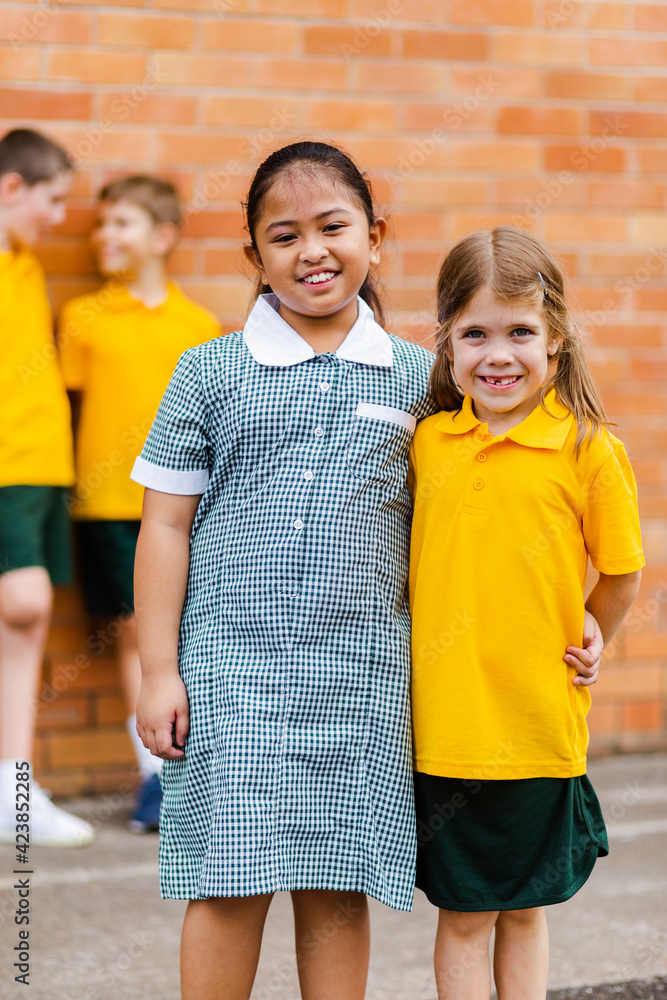 Happy school friends with different ethnicities smiling together happy to be back to school Happy school friends with different ethnicities smiling together happy to be back to school